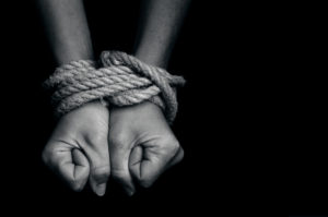 human trafficking, hands tied with rope