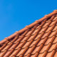 Red roof tiles against a blue sky