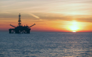 Offshore oil and gas rig at sunset