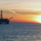 Offshore oil and gas rig at sunset