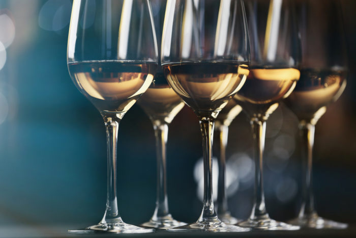 Glasses of white wine on a blurred background