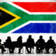 Business meeting under a South African flag