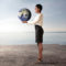 Businesswoman holding globe in arid landscape
