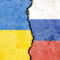 Ukrainian and Russian flags painted on a wall